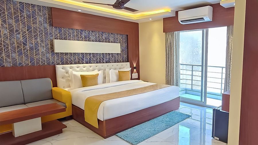 Junior Suite with a king size bed, a sofa, and modern decor a t Yashshree Bangla Queen, Digha.