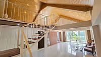 A view of the interior architecture featuring a stylish staircase leading to an upper level, highlighting the design of Yashshree Resorts & Spa, Kalimpong.