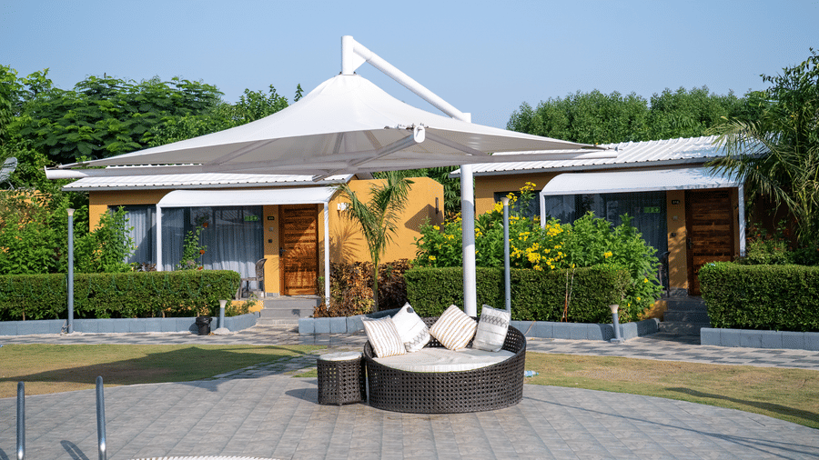 Outdoor gazebo seating area with greenery at Lords SKD Resort, Salangpur.