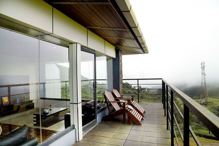 Shot of the balcony at the villa with chairs kept | Ibex Stays and Trails, Valparai (Tale Rock)