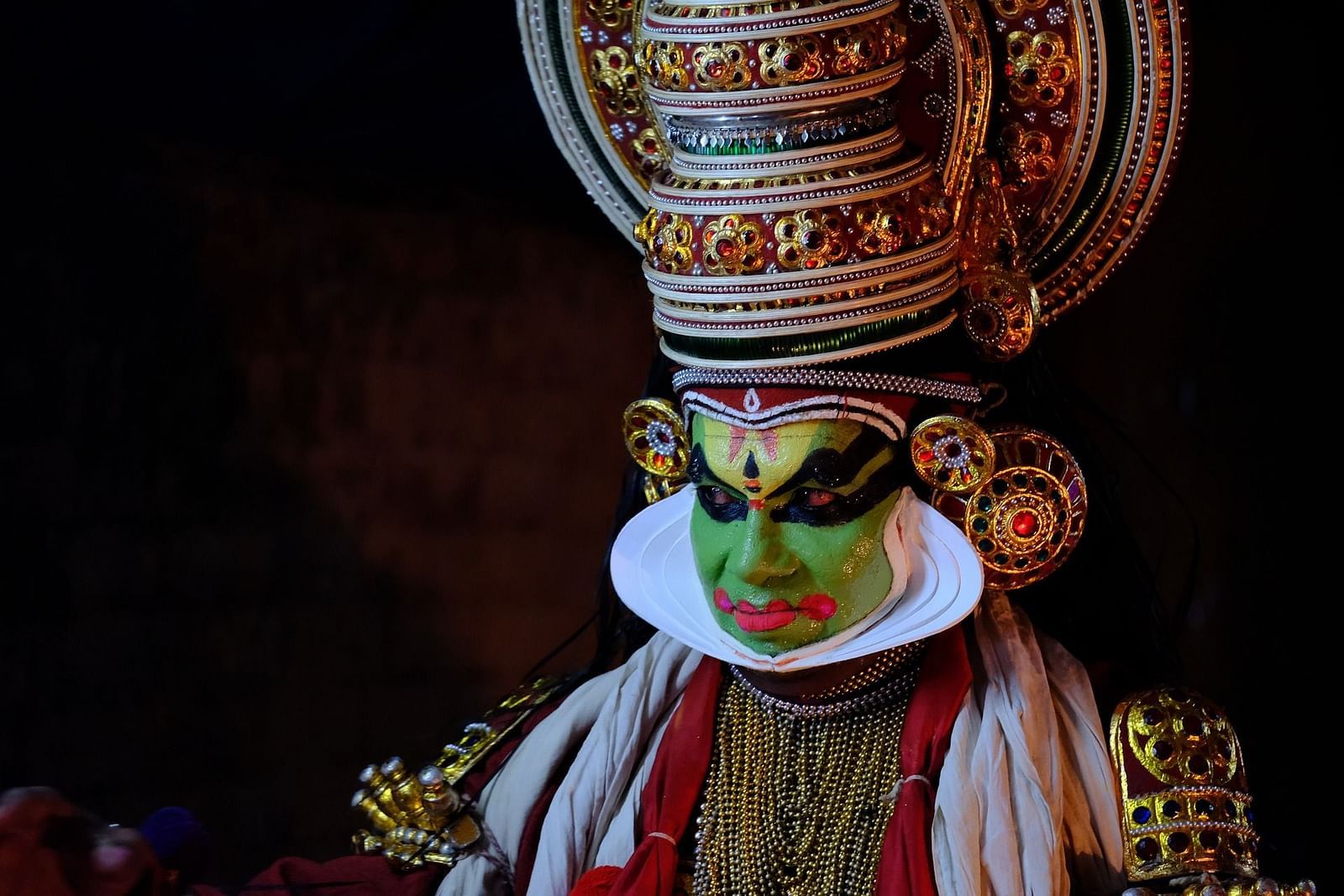 a kathakali model dressed in cultural uniform