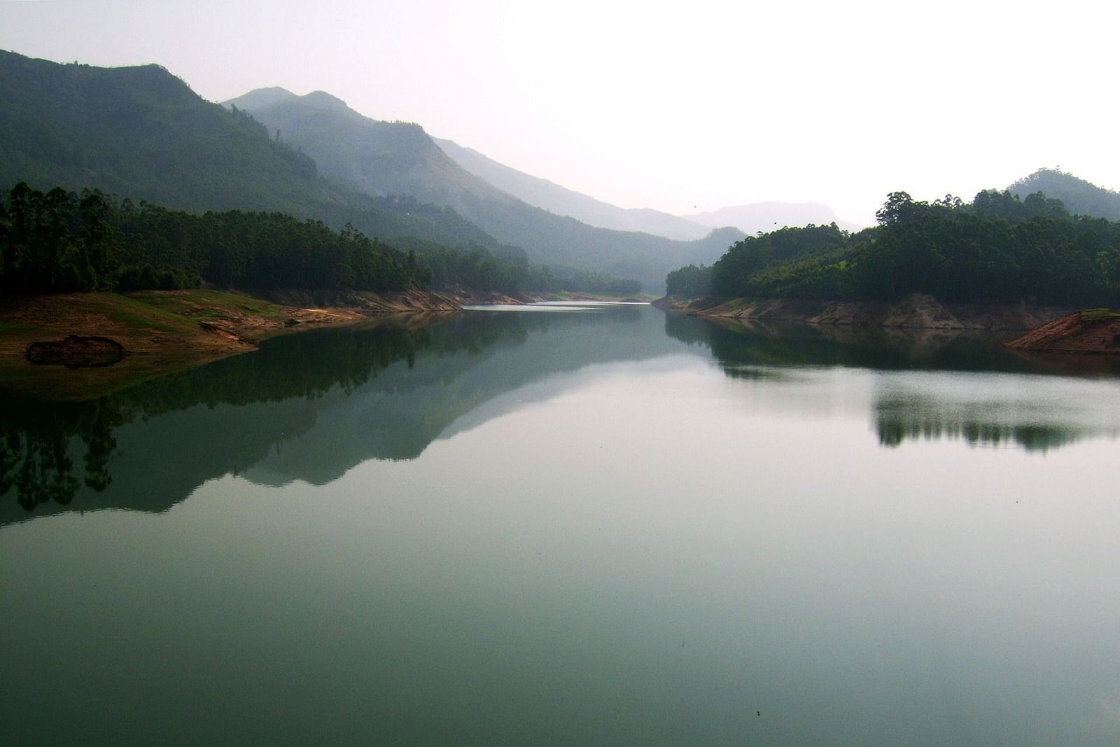 an image of a river moving between two mountains