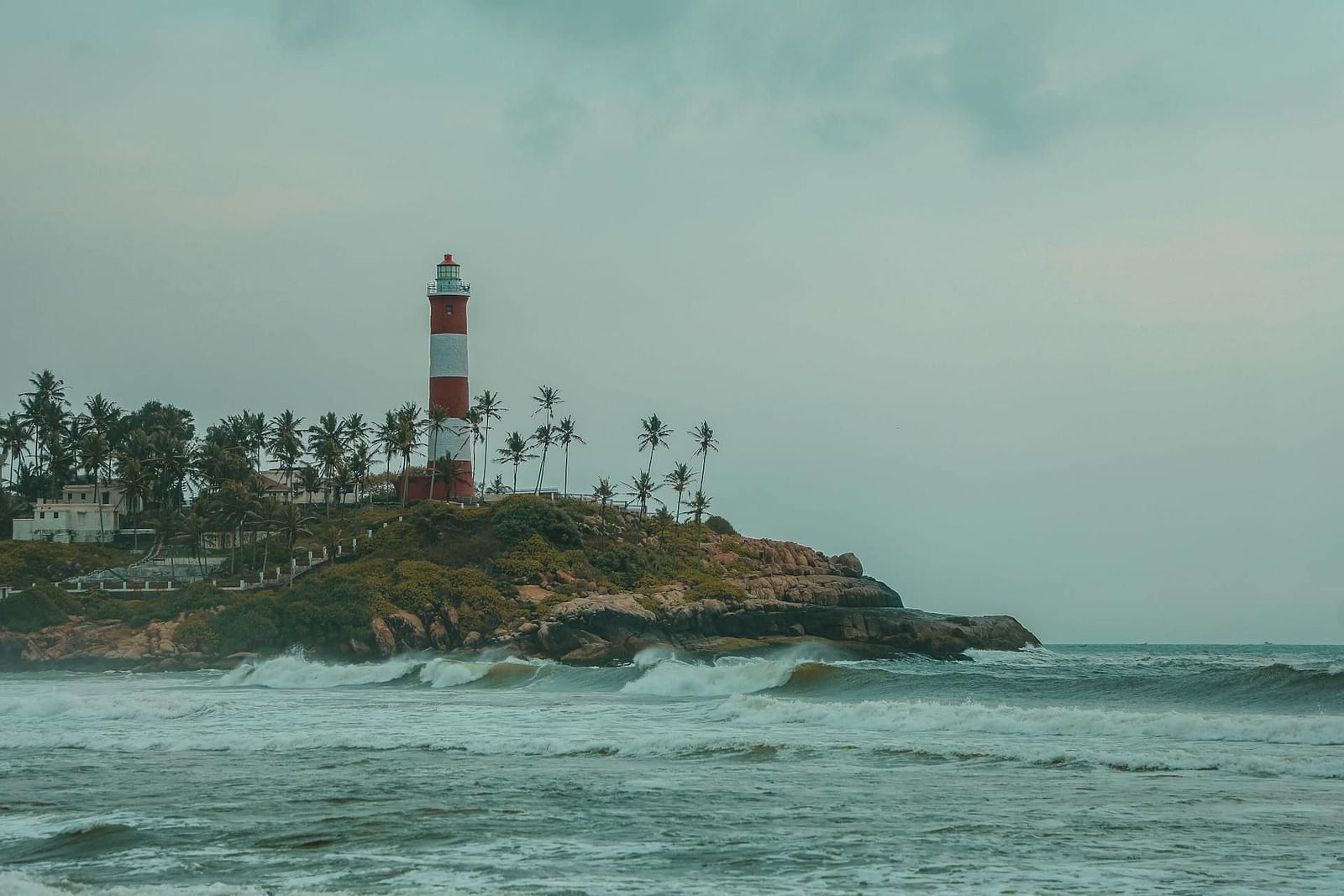 an image sea with a tall lighthouse standing on a rocky cliff.