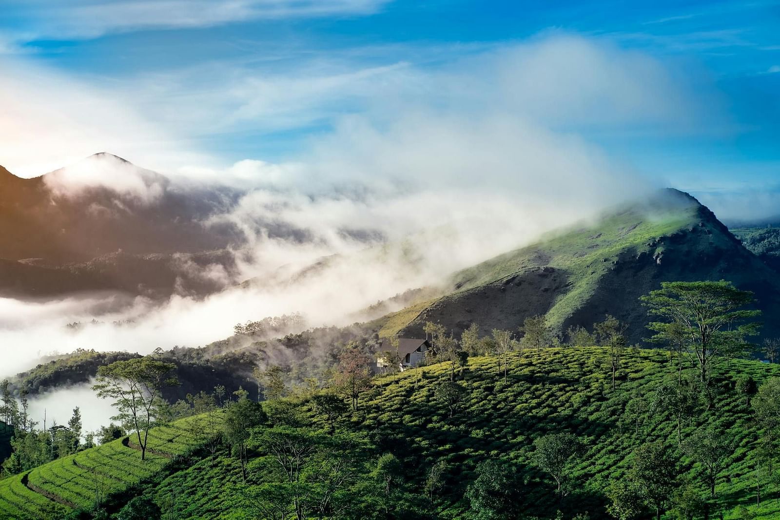 an image of a mountain stands tall as soft clouds cascade down its slopes like a gentle waterfall.