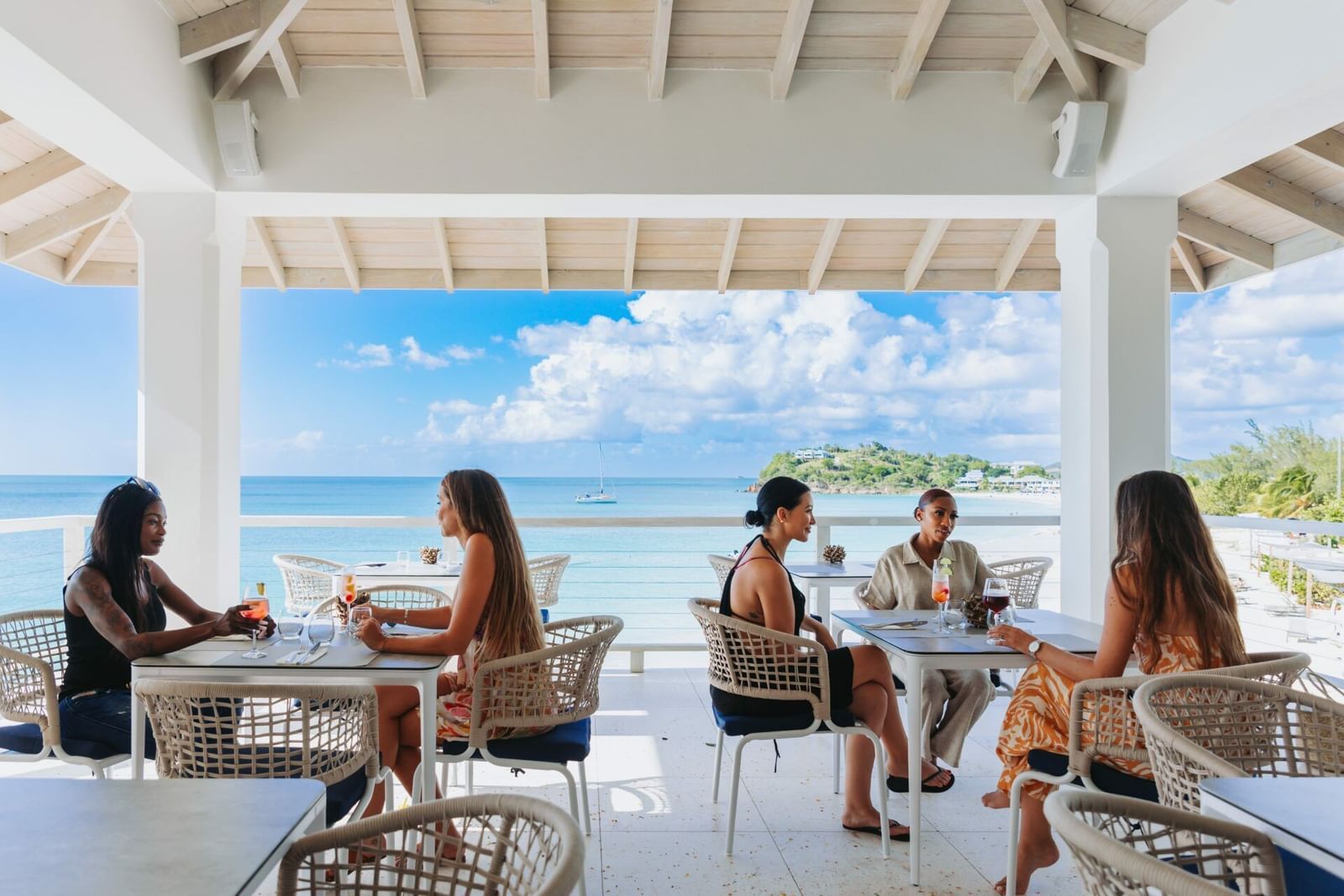 A seaside dining experience at Tamarind Hills Resort and Villas Antigua, a luxury resort in Antigua offering breathtaking ocean views and refined ambiance.