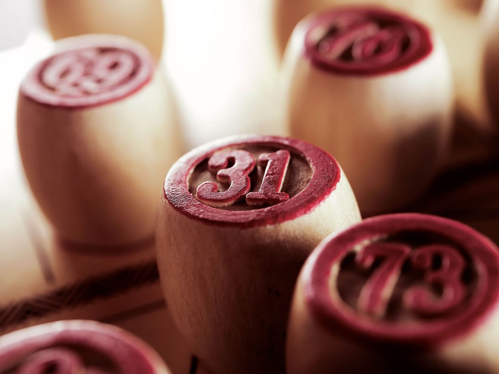 A close up shot of wooden pieces with numbers on them that are used for Tambola at Rhythm Lonavala.