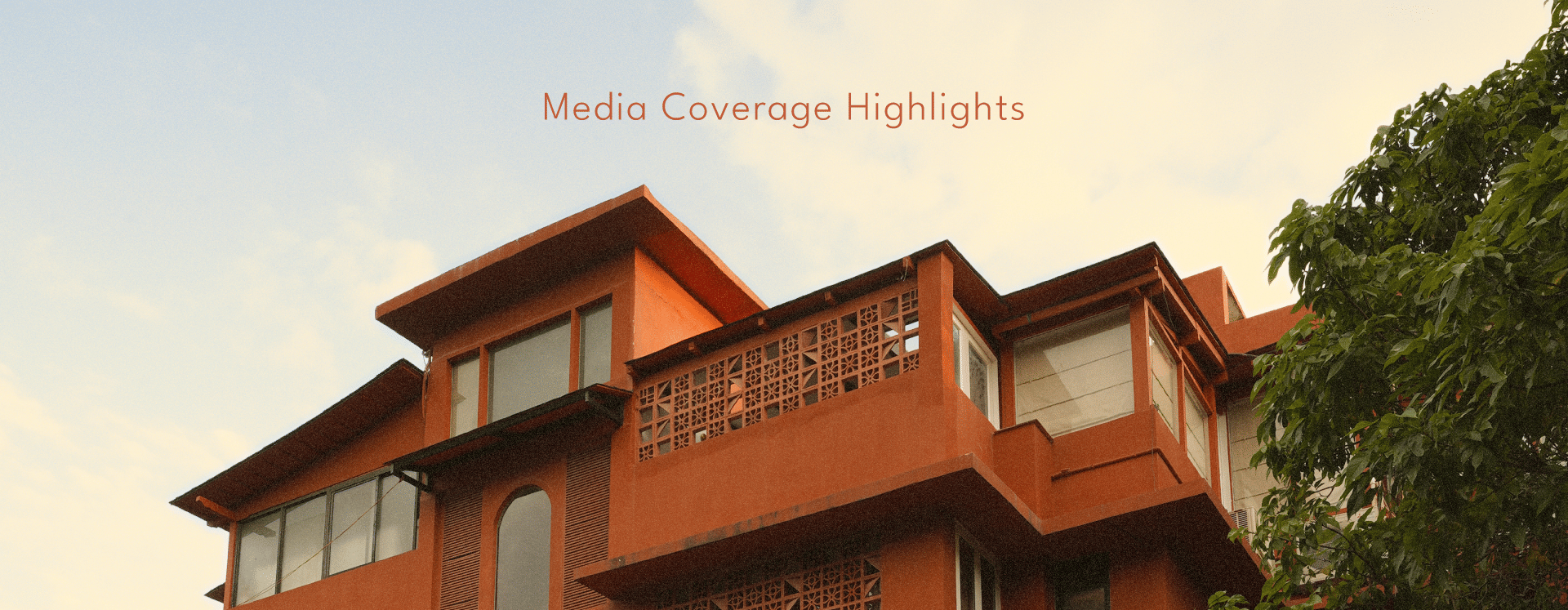 A rustic building with trees nearby and text that says. 'Media Coverage Highlights' for The Unseen Assagao.