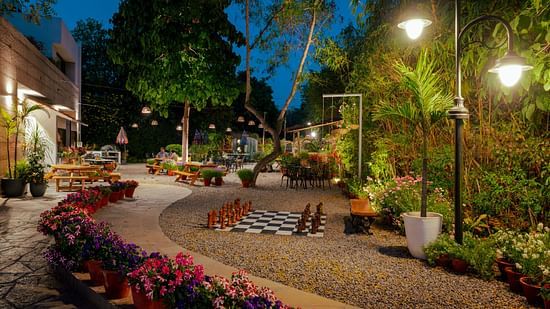 large chess set outside under the neem