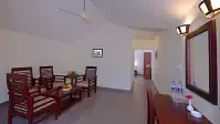 Spacious room with dining set, mirror, and wall lights. - Abad Brookside Lakkidi, Wayanad