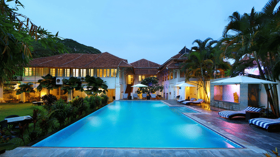The Tower House in Fort Kochi featuring a pool with clear blue water captured during dusk
