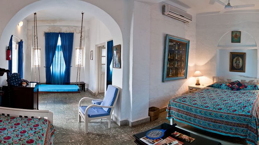 Hindola Mahal - Countryside View offers a spacious bed and an archway that leads to the living area - Hill Fort Kesroli Alwar Rajasthan