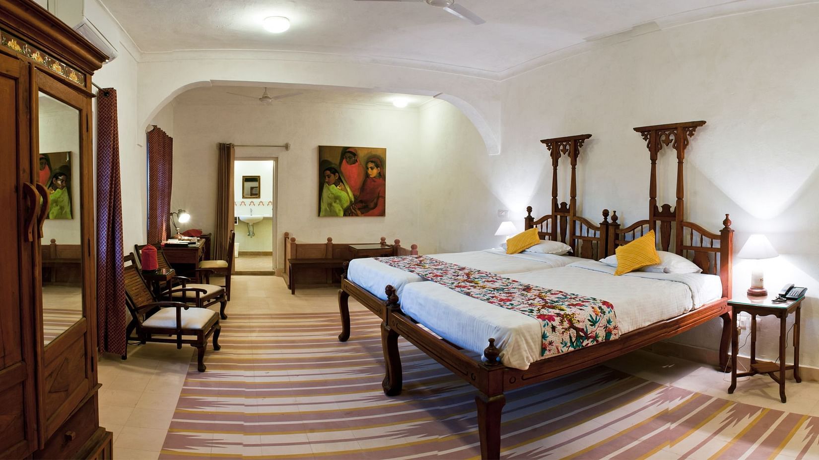 Hill Fort Kesroli 14th Century Alwar - interior view of the Pratap Mahal - Countryside View room with a wooden wardrobe,  twin beds and lamps on either sides of the beds