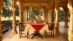 Deo Bagh - 17th Century, Gwalior - an outdoor dining seating arrangement at the arch-shaped hallway