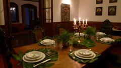 A set dining table with crockery, glasses and a candle lamp on the table - Wallwood Garden - 19th Century, Coonoor