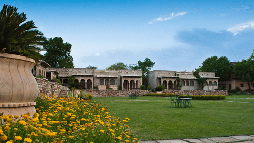 A panoramic view of Deo Bagh - 17th Century, Gwalior, our resort in Gwalior during daytime featuring lawn and flowers and a seating space