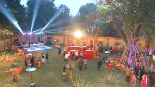 an aerial view of the garden with food counters and the stage during a wedding - The Baradari Palace