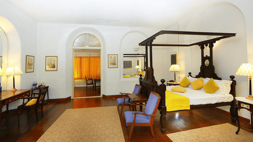 The Tower House - The Wayermah room The Tower House with white linens and room amenities like a wardrobe, a workdesk and electric kettle