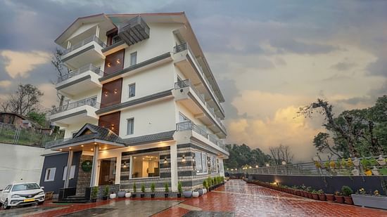 Facade image of Stone Wood Mountain Resort, Dharamshala with the parking area in view