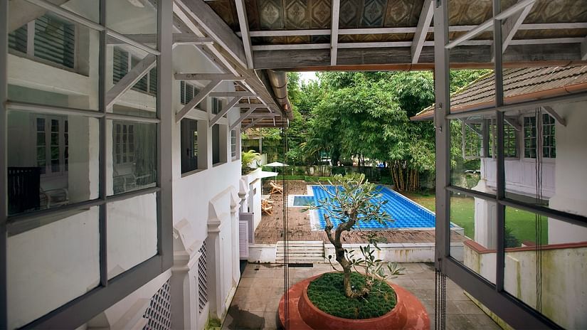 The Tower House - The pool view from a first floor window surrounded by green trees