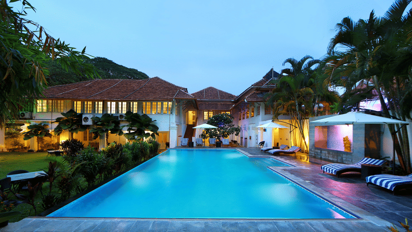 The Tower House in Fort Kochi featuring a pool with clear blue water captured during dusk