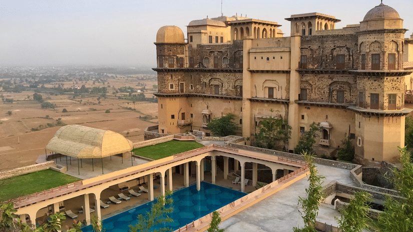 Facade view of Tijara Fort-Palace - 19th Century, Alwar with clear blue sky in the background.