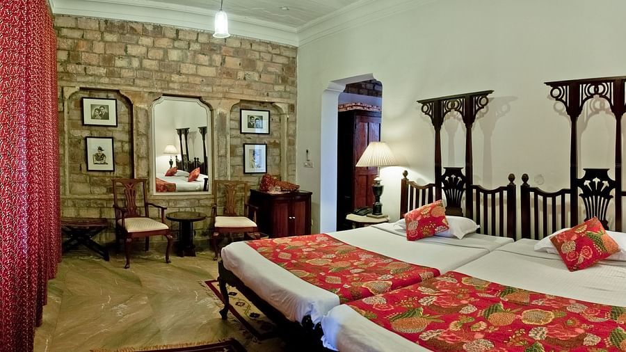 Deo Bagh - 17th Century, Gwalior - twin sharing beds located opposite to the brick-designed wall at Dhruv Mahal