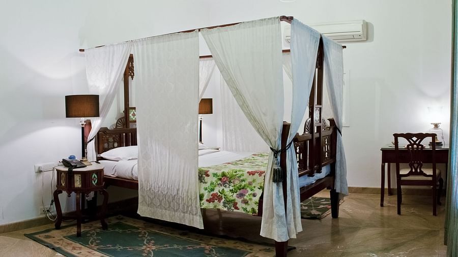 Deo Bagh - 17th Century, Gwalior - view of a king size bed covered in sheets at Jankoji Mahal - Naubagh / Garden View room in Gwalior