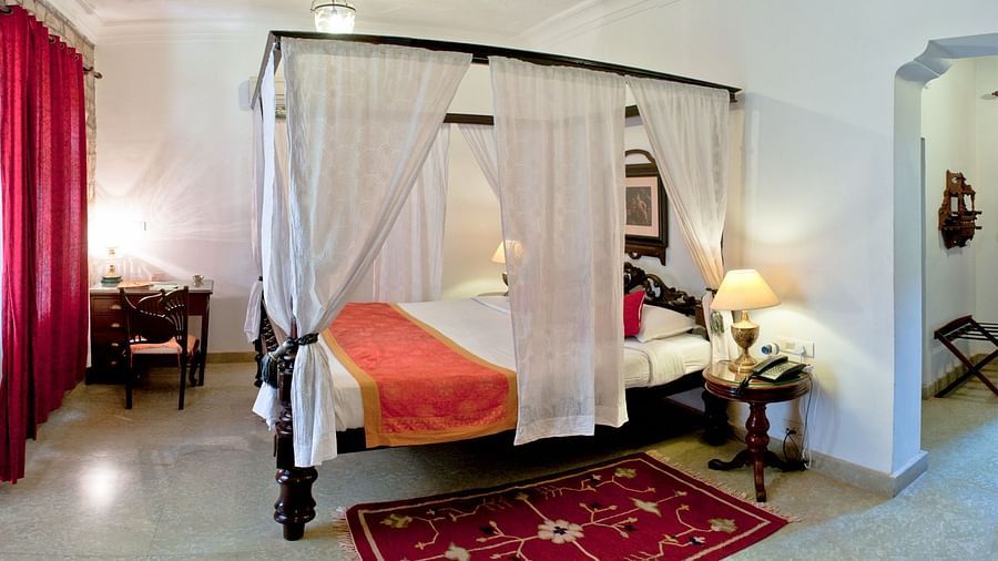 Deo Bagh - 17th Century, Gwalior - a king size bed covered with sheets at the Jayaji Vilas - Naubagh / Garden View