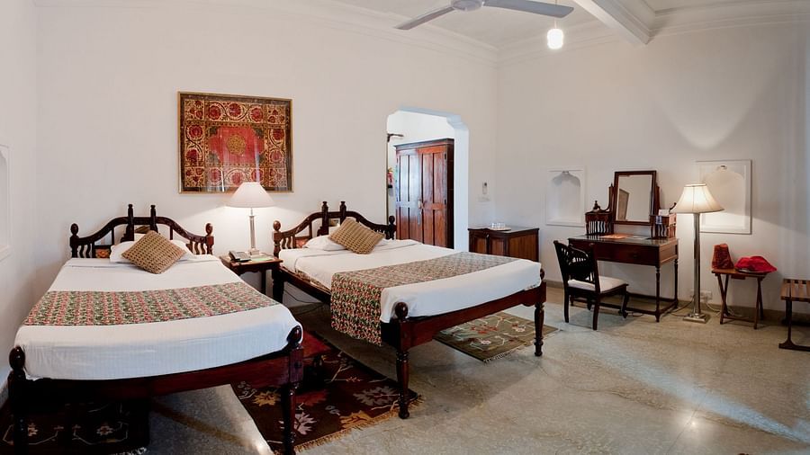 Deo Bagh - 17th Century, Gwalior - a wall painting hanging on top of twin sharing beds at the Madhav Mahal - Naubagh / Garden View