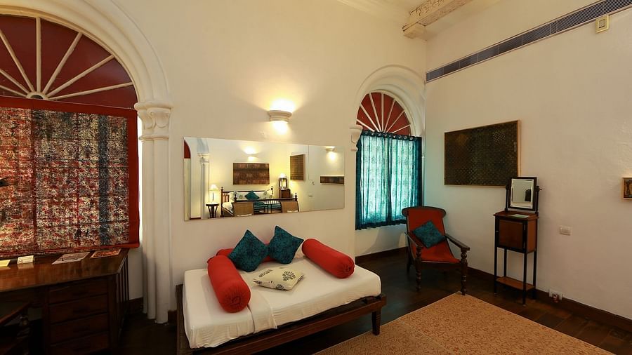 The Tower House - The Mateu room with a single bed next to a workdesk and a wall mirror