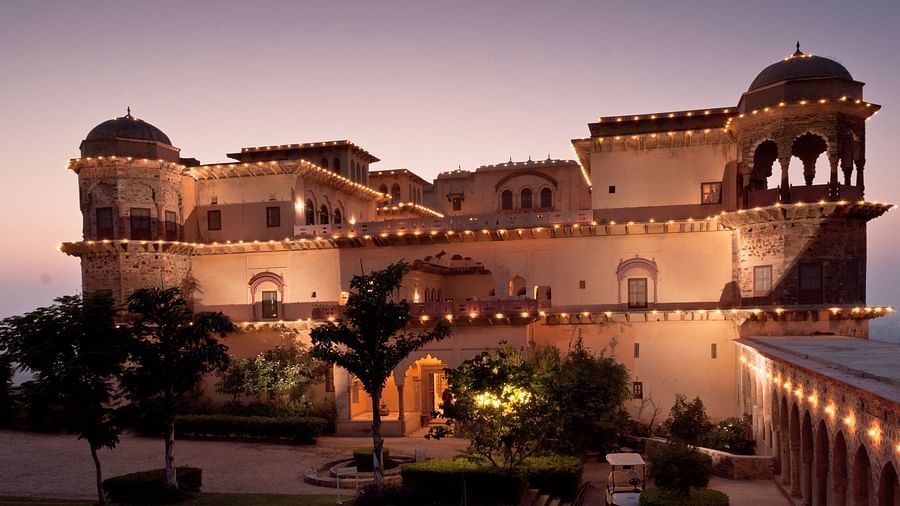Facade shot of Tijara Fort-Palace - 19th Century, Alwar with colourful sky in the background.