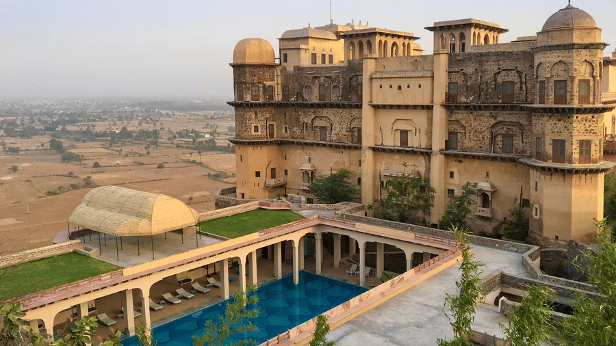 Facade view of Tijara Fort-Palace - 19th Century, Alwar with clear blue sky in the background.