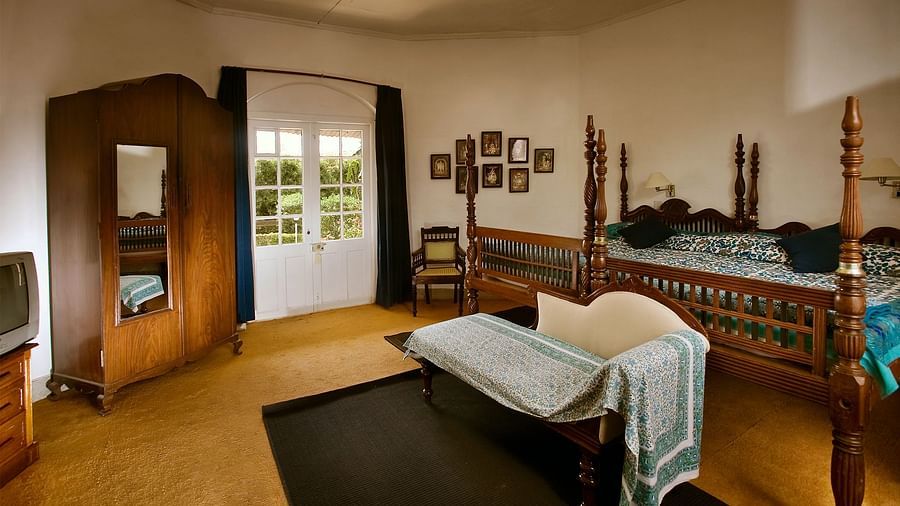 Two double beds combined to make a huge king size bed with a sofa at the end and a wardrobe on the side inside Pine room - Wallwood Garden - 19th Century, Coonoor