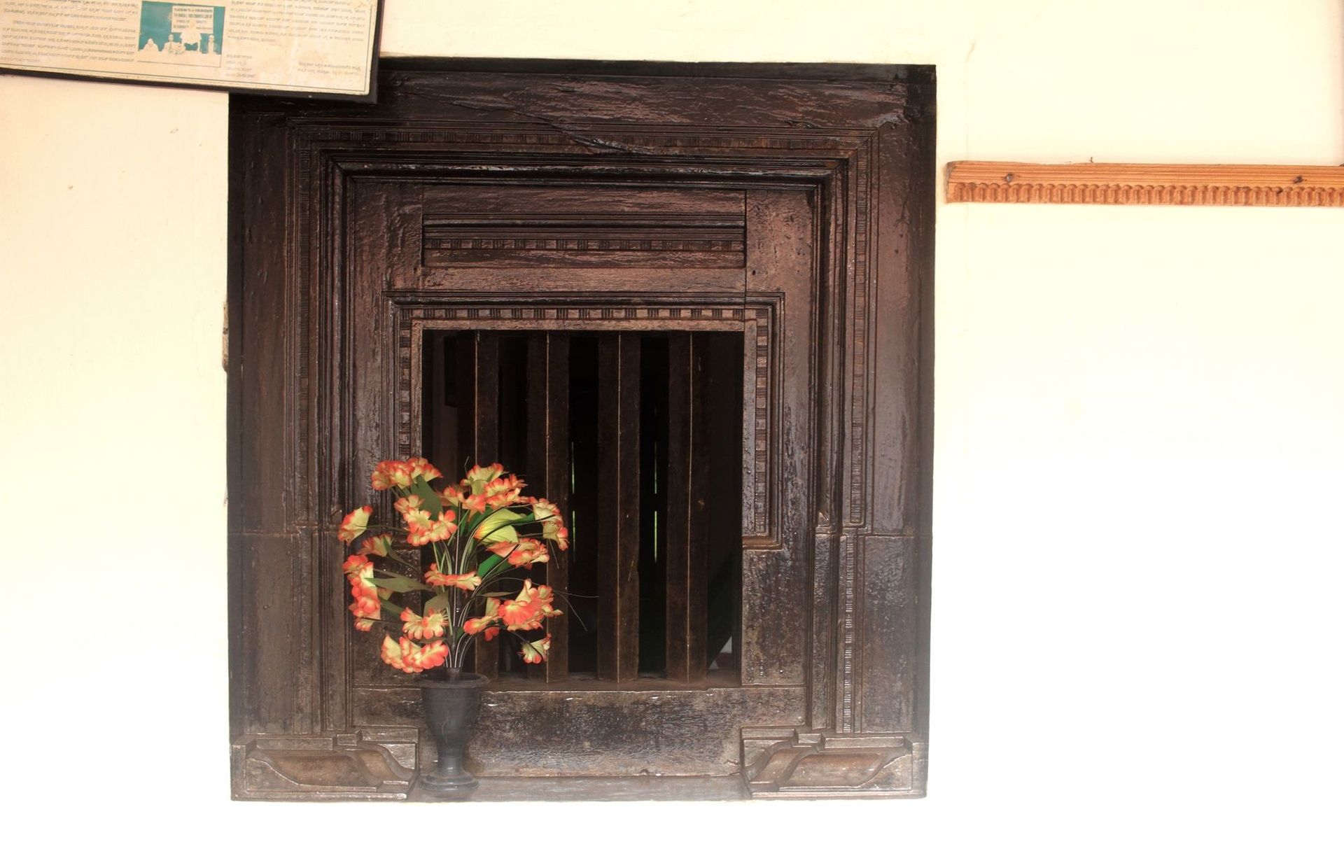 Ornate antique wooden window frame with carved detailing.