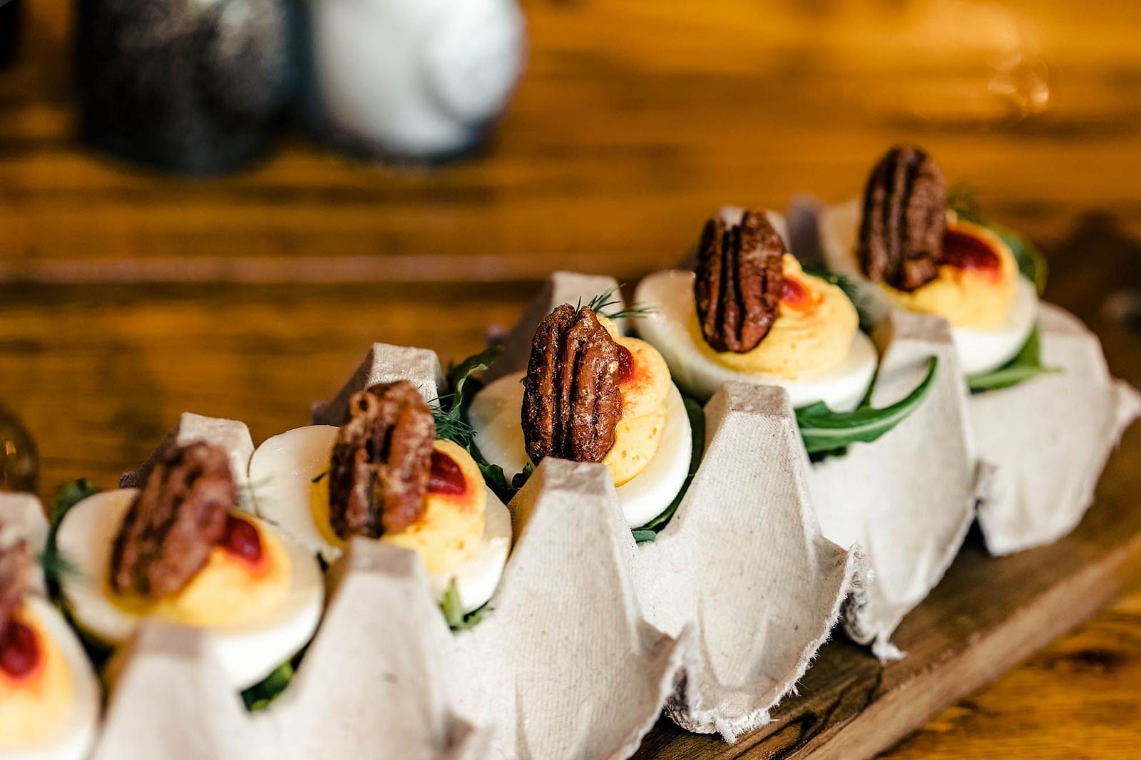 A close-up of a dish, arranged neatly on a wooden serving board.- The Grand Hotel & Ballroom, McKinney