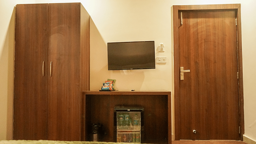 Deluxe Room at Five Elements Hotels, Haridwar, with a wall-mounted TV and a corner wardrobe