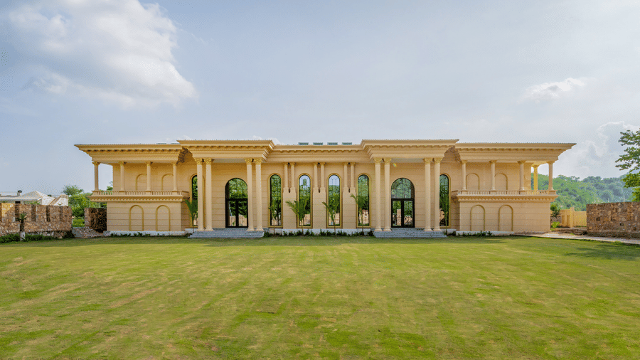 Facade of The Royal Knot banquet hall with a spacious forecourt at Valley by Grassfield, a wedding resort in Jaipur.