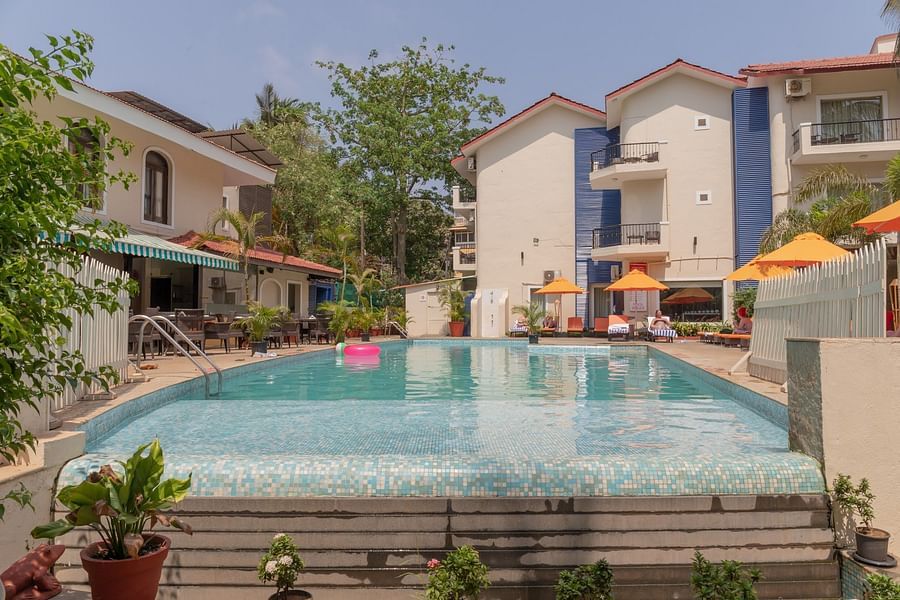 Pool surrounded by buildings at Kyriad Prestige Calangute, Goa