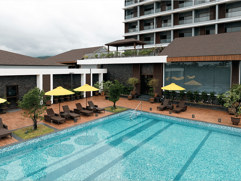 An overhead view of the swimming pool and sun loungers at Cloud9 Sarovar Premiere, Palolem Goa, showcases a relaxing and inviting atmosphere