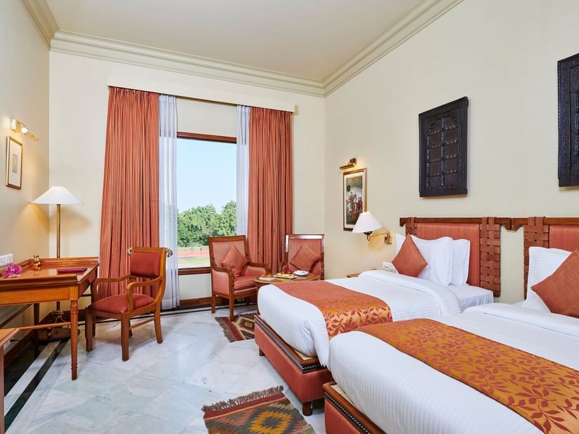 a deluxe room with twin bed featuring soft white linens and a window offering great view - The Ummed Jodhpur, Palace Resort and Spa