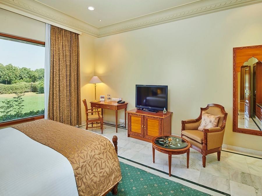 a closer view of luxe bedroom with comfy bed and amenities like a television - The Ummed Jodhpur, Palace Resort and Spa