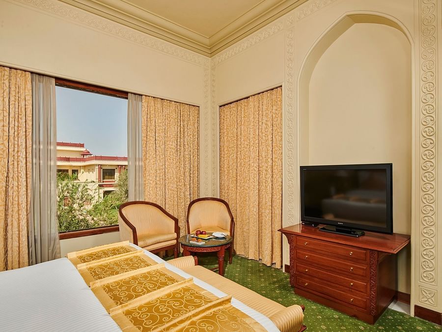 corner view of luxury suite with showcasing a television on a cabinet  - The Ummed Jodhpur, Palace Resort and Spa