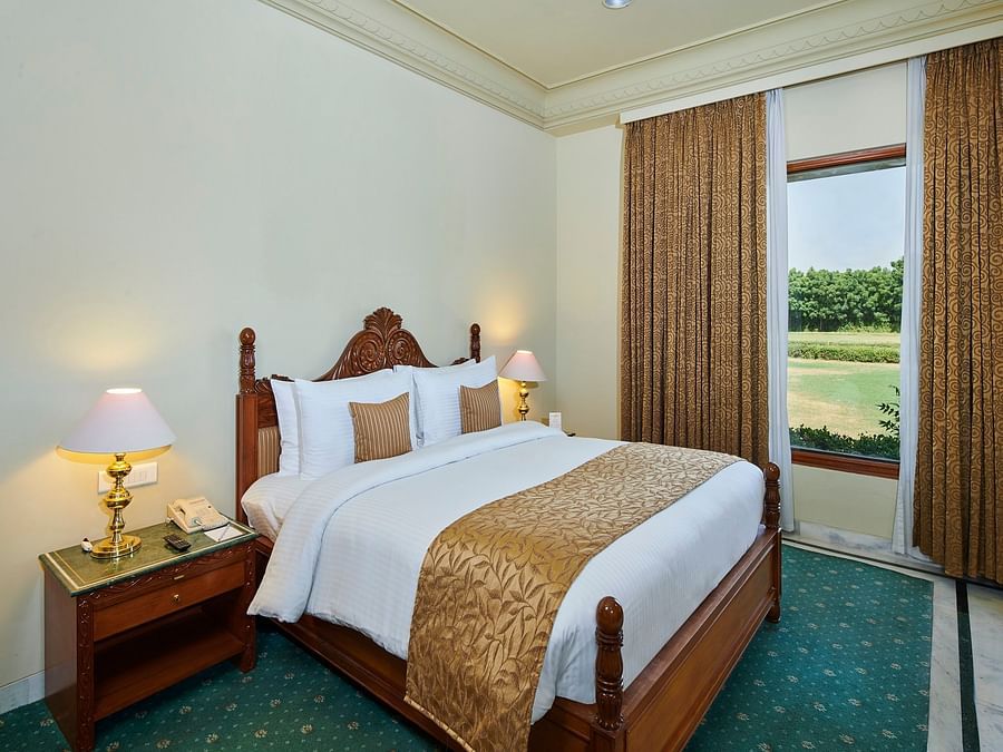 a suite bedroom with cosy bed and superior interior featuring a window next to the bed - The Ummed Jodhpur, Palace Resort and Spa