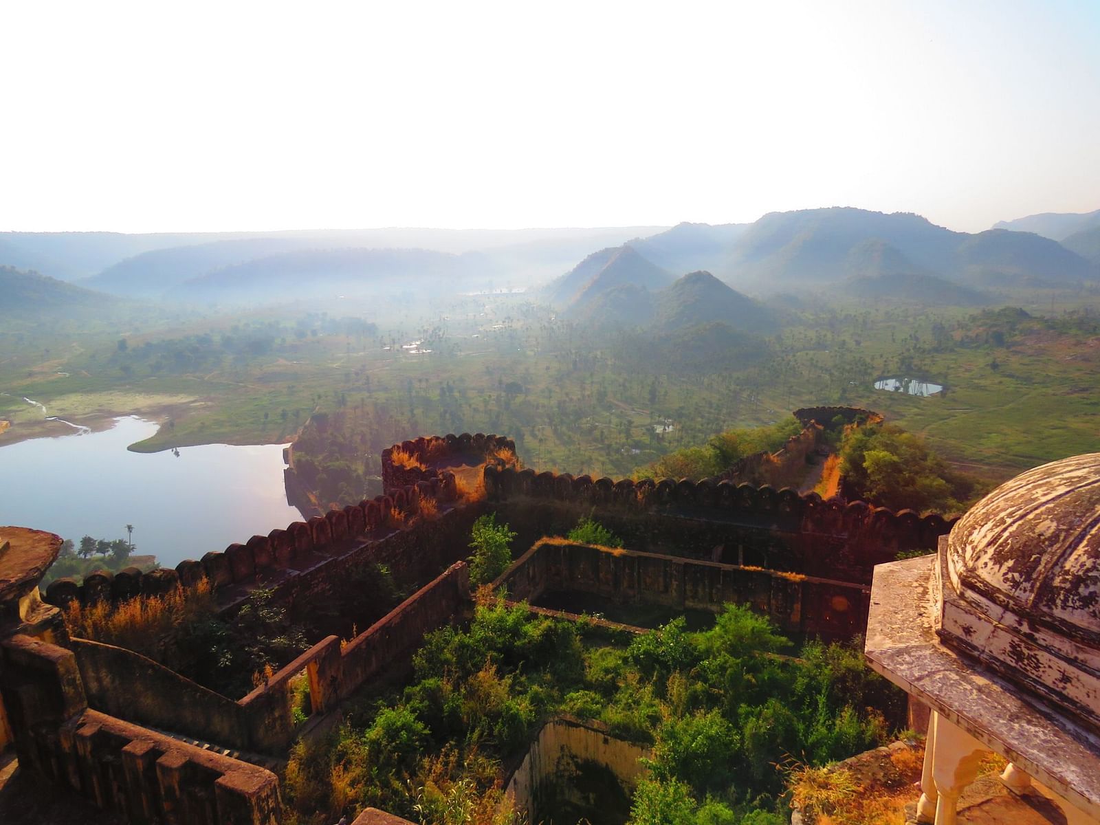 Aerial view of Kankawari fort near alwar Rajasthan showcasing a lake next to it 