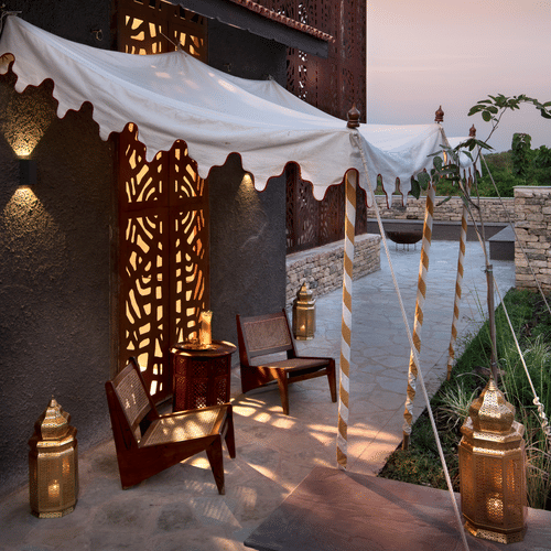 vintage tent shadow falling on small chairs 