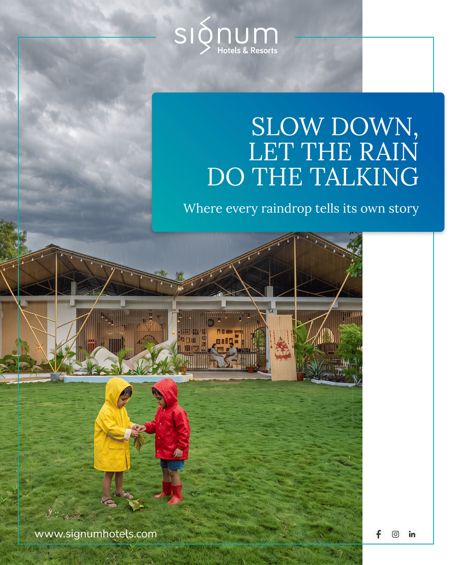 Two children in raincoats playing on the resort lawn during the monsoon