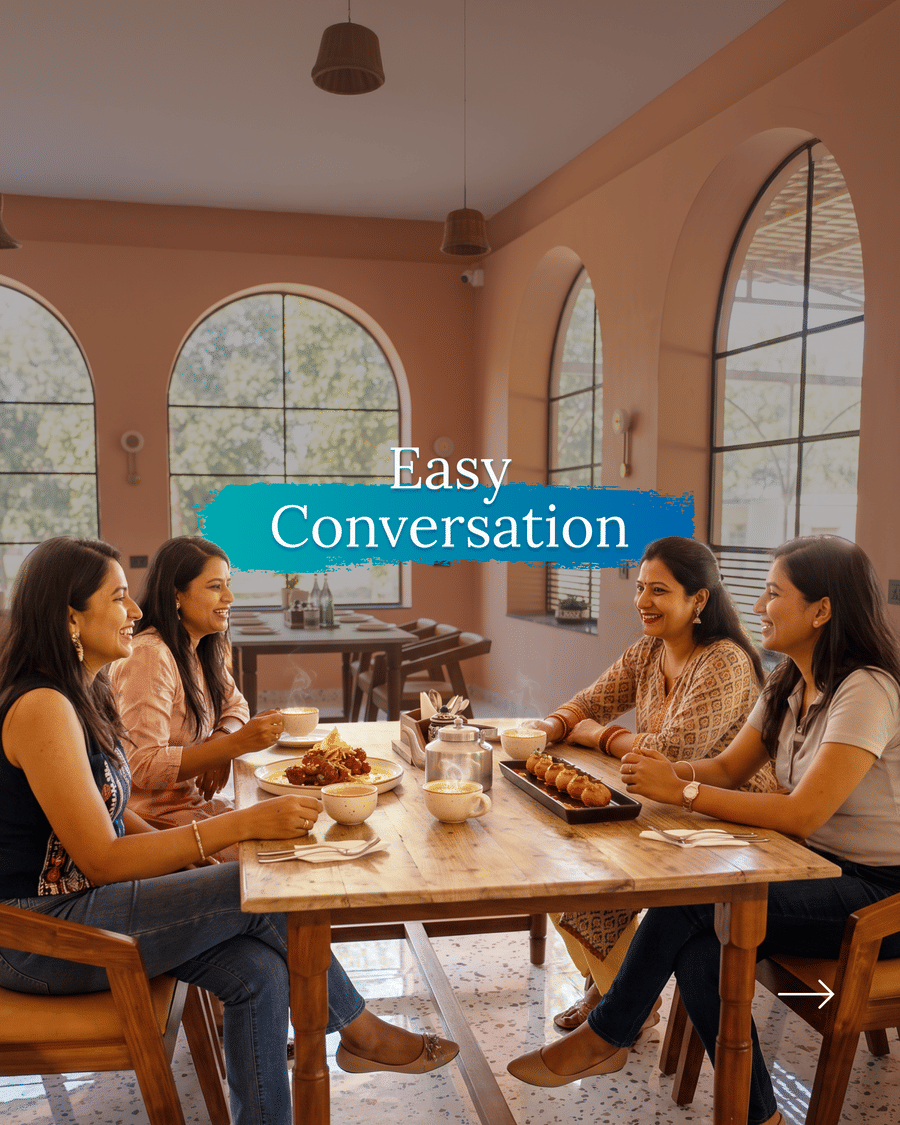 Four women guests in conversation over coffee in the dining room, captioned Easy Conversation