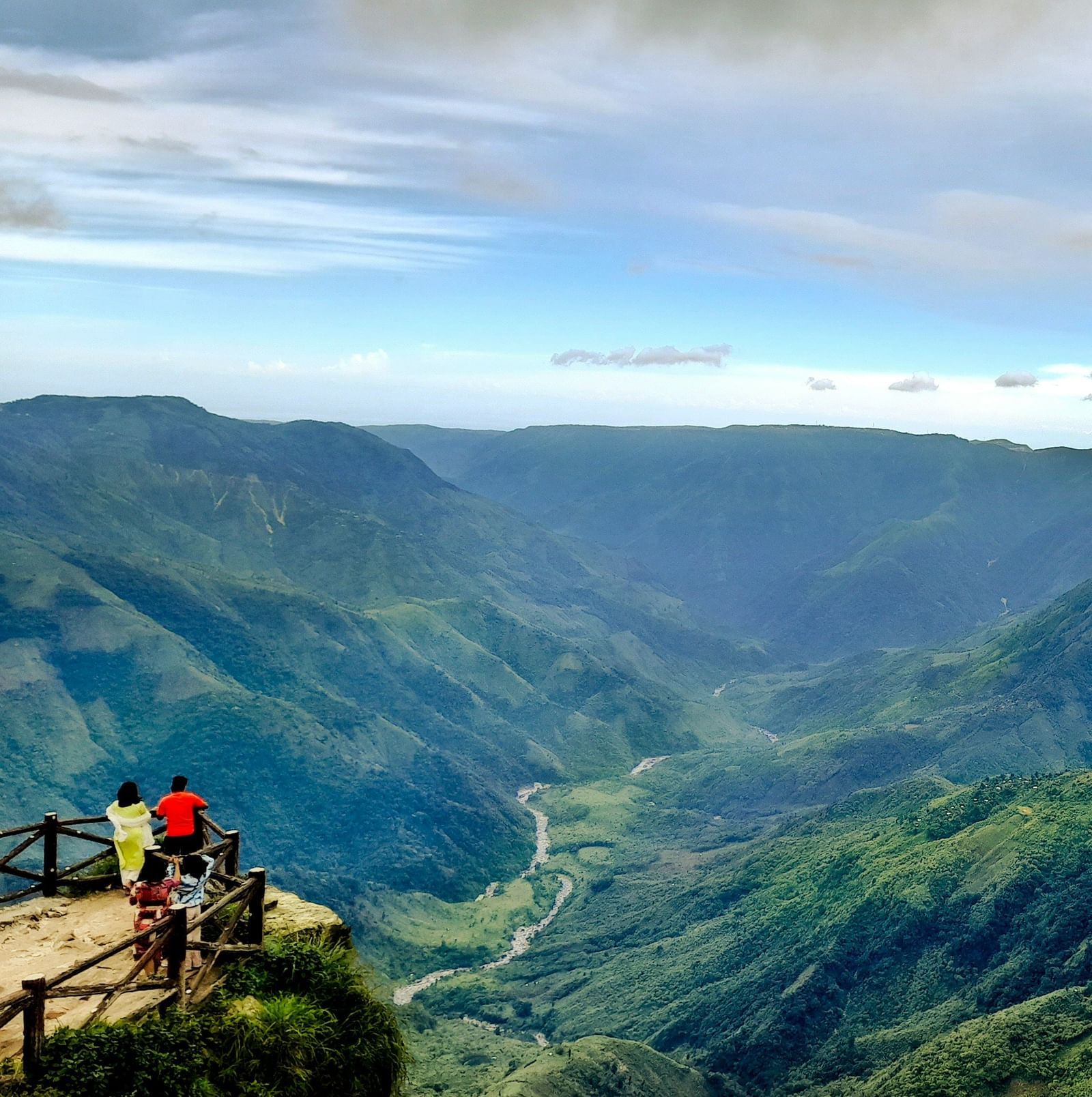 An aerial view of the rolling hills in the Northeast with a group of tourists overlooking them from a view point.