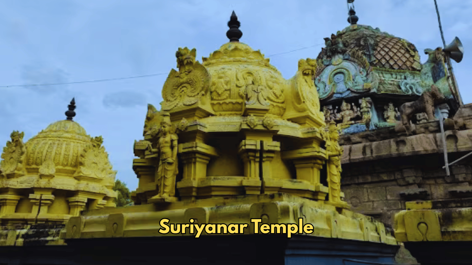 Domes and towers form the architecture of Suriyanar Temple. Carvings of figures stand on the roof sections.