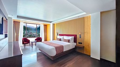 Full view shot of the Premium View Room featuring a double bed along with mesmerising views from the window - Yashshree Lachen